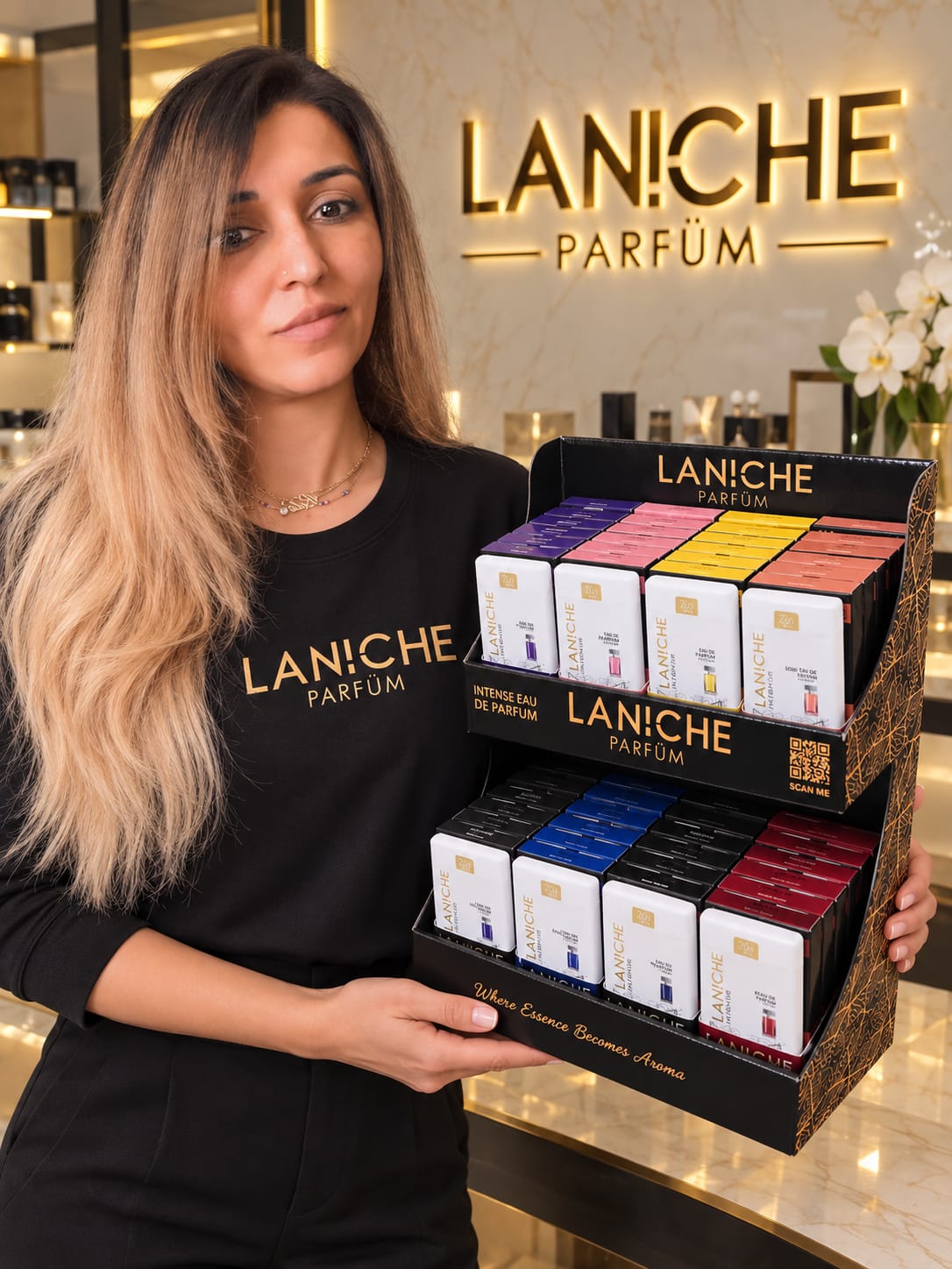 Rida, founder of Laniche Parfum, holding the pocket perfume display